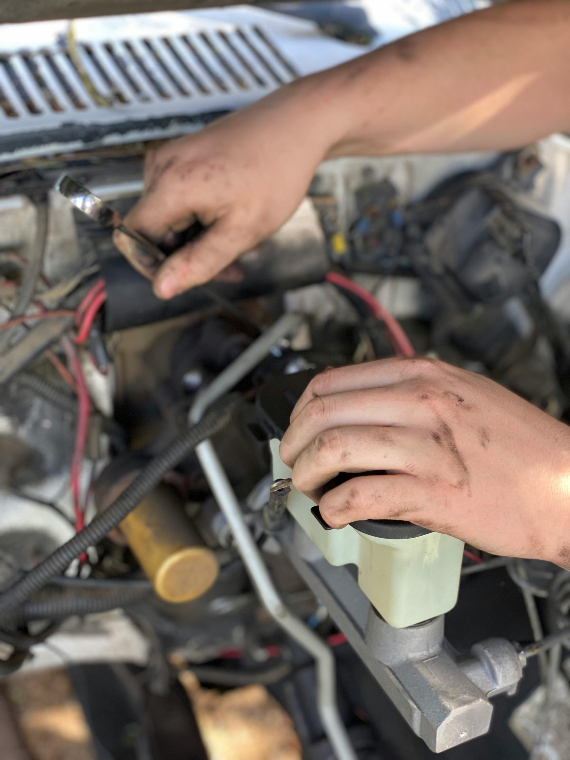 A machanic is replacing brakes oil.